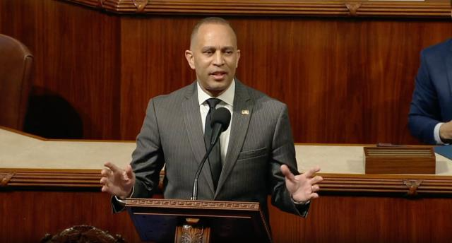 Leader Jeffries speaks behind the dais on the House Floor