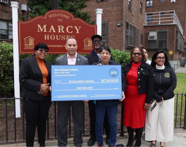 LHJ presents a large check to Marcy Houses