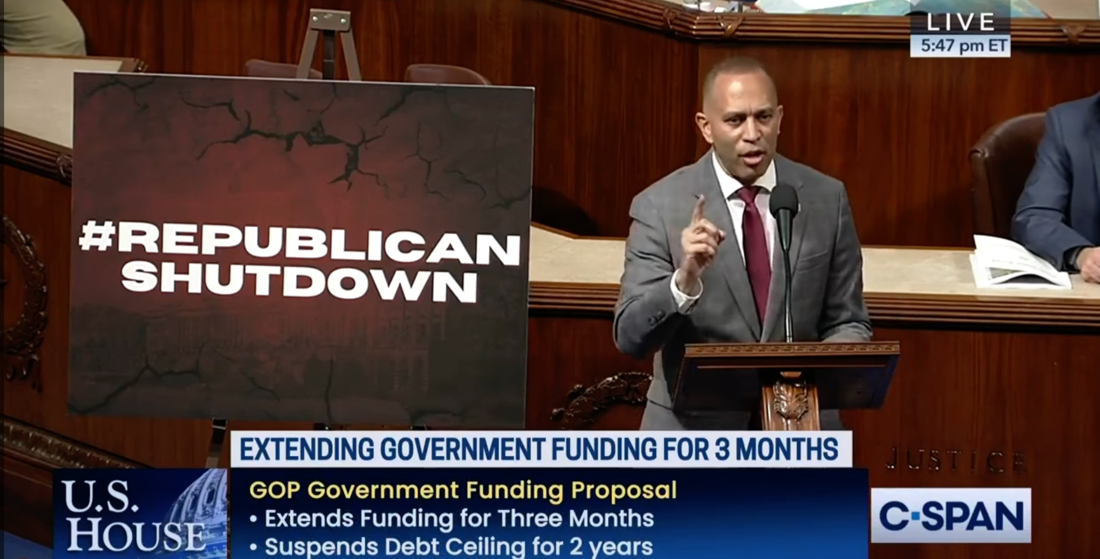 Leader Jeffries speaks on the House Floor in front of a sign that reads #RepublicanShutdown